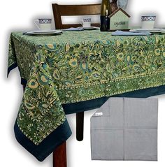 the table cloth is green and has blue trimmings on it, along with two place settings