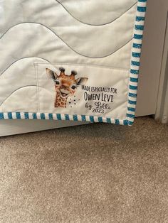 a giraffe quilted on the side of a door