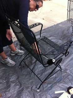 a man bending over to pick up an empty chair