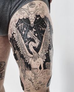 a man with an eagle tattoo on his thigh and leg is standing in front of the camera