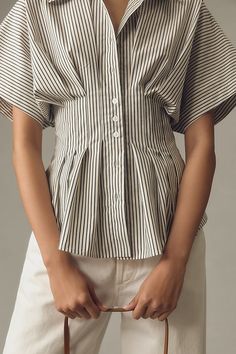 Tailored to perfection, the Tobie Shirt is on top of everyone’s mind – with its classic collar, exaggerated sleeves, and waist-defining pleats. | The Tobie Pleated Blouse by Exquise: Short-Sleeve Edition, Women's, Size: 1 X, Polyester/Cotton/Elastane at Anthropologie Casual Pintuck Short Sleeve Tops, Classic Fitted Tops With Pleated Sleeves, Casual Short Sleeve Tops With Pintucks, Casual Pleated Short Sleeve Blouse, Chic Pleated Waist Spring Tops, Casual Short Sleeve Pleated Blouse, Fitted Pintuck Tops For Workwear, Short Sleeve Tops With Pintucks For Daywear, Spring Pleated Short Sleeve Blouse