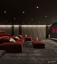 a large red couch sitting in the middle of a living room next to a flat screen tv