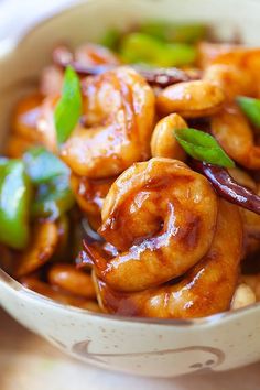 a bowl filled with shrimp and vegetables on top of a table