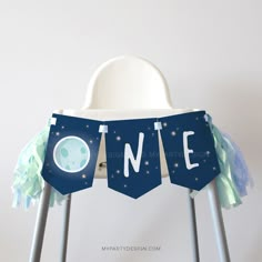 a blue banner with the word one hanging from it's side on top of a chair