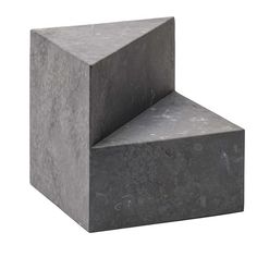 a gray concrete block sitting on top of a white background