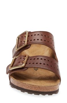 Perforations on the toe and brassy buckles give a stylish update to the classic Arizona sandal built with the same contoured footbed for comfort. Contoured footbed with arch support Leather upper and lining/synthetic sole Imported Classic Brown Slip-on Footbed Sandals, Classic Leather Footbed Sandals With Adjustable Fit, Classic Adjustable Slides With Leather Footbed, Classic Adjustable Leather Footbed Sandals, Classic Slide Sandals With Cushioned Footbed, Classic Slide Footbed Sandals With Cushioned Footbed, Classic Cushioned Slide Footbed Sandals, Classic Brown Sandals With Arch Support, Classic Comfort Slip-on Footbed Sandals