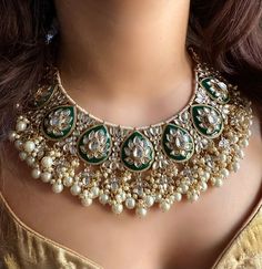 Adorn yourself with exquisite Bridal Kundan Jewellery in stunning shades of green and off white pearls. This Wedding jewellery, inspired by Indian and Pakistani traditions, features intricate designs including Jhumka earrings, Maangtika (forehead ornament), and Punjabi-inspired elements.  With vibrant ivory accents and green Meenakari work, this jewellery set is the perfect complement to your Indian wedding ensemble, radiating timeless beauty and capturing the essence of cultural heritage. Item includes: Necklace, earrings and maangtika Ready to be shipped with love from New Delhi, India  Please leave your phone number in notes or message when placing order for this item. Luxury Green Bridal Necklace For Diwali, Pista Green Jewellery Set, Luxury Green Meenakari Jhumkas, Elegant Green Meenakari Lehenga, Elegant Green Lehenga With Meenakari, Festive Green Kundan Necklace With Mirror Work, Green Kundan Tikka For Eid, Festive Kundan Chandbali Pearl Necklace, Green Kundan Necklace With Mirror Work For Diwali