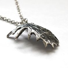 "This shed moose antler pendant is made of solid sterling silver. The recesses of the antler have been darkened to enhance the realistic veined texture of the palm. This stunning trophy antler pendant measures 1\" wide and 1-1/4\" long and is finished on all sides as shown so there is no \"wrong\" side. MOON RAVEN DESIGNS: Please check out the rest of our shop by clicking: http://www.etsy.com/shop/mrd74?ref=si_shop QUESTIONS: We are always happy to answer any of your questions, so please contact Antler Pendant, Moose Antlers, Wolf Ring, Button Studs, Antler Necklace, Silver Wolf, Western Jewelry, The Palm, Antlers