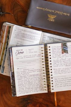 an open notebook sitting on top of a wooden table