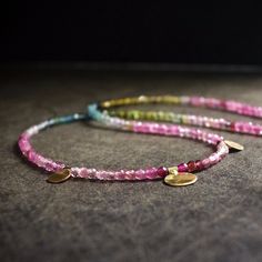 I adopt a unique approach that sets it apart. Unlike the conventional methods, I take special care to rearrange each tiny bead deliberately. This meticulous process achieves a subtle gradient of colors, ensuring a seamless transition between various shades of tourmaline. The result is a necklace of exceptional beauty and harmony. Investing extra time and effort into this careful arrangement allows me to fashion a distinctive and personalized piece, showcasing the complete spectrum of colors inherent in tourmaline. Tourmaline 2.5mm 14K Solid gold 15 inches / 38.1cm 【!!】 While the color of the necklace you receive may vary slightly, I'm committed to ensuring it maintains the same artistic beauty as depicted in the listing photos. 【Please Handle with Care】 A lot of my jewelry showcases dainty Bohemian Tourmaline Jewelry With Natural Stones, Bohemian Tourmaline Bead Jewelry, Handmade Tourmaline Bohemian Jewelry, Bohemian Tourmaline Round Bead Necklaces, Tourmaline Beaded Necklace For Gift, Bohemian Tourmaline Bead Necklaces, Dainty Tourmaline Gemstone Beads Jewelry, Handmade Bohemian Tourmaline Necklace, Bohemian Tourmaline Round Beads Jewelry