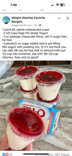 three plastic cups filled with yogurt sitting on top of a counter next to a package