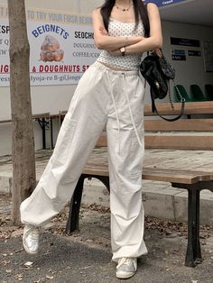 Features: These White Y2K Cargo Pants are a versatile piece that combines fashion with functionality. With a high waist and loose fit, they offer comfort and style that is perfect for any occasion. The lace-up detail adds a touch of American Harajuku style, making them a must-have addition to any wardrobe. Made with high-quality materials, these pants are durable and long-lasting. Upgrade your wardrobe with these vintage-inspired cargo pants. White Baggy Drawstring Pants, Chic Drawstring Cotton Pants, Baggy Wide Leg Pants With Drawstring, Spring High-waisted Wide Leg Pants With Drawstring, Spring Drawstring High-waisted Wide Leg Pants, Streetwear Wide Leg Drawstring Pants, Casual Wide Leg Pants With Drawstring, Spring Baggy Wide-leg Parachute Pants, Spring Relaxed Fit Parachute Pants With Drawstring