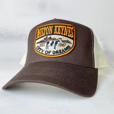 Milton Keynes City Of Dreams , Buckinghamshire - vintage style retro trucker cap - brand new. Condition is New with tags.  This is the brown version. The cap is wrapped in tissue paper and shipped in a rigid box so it'll arrive in perfect condition. Brilliant exclusive design, not available anywhere else. Great conversation starter and gift for residents of Milton Keynes. Retro Trucker Hat With Embroidered Logo, Retro Trucker Hat With Embroidered Logo And Curved Bill, Brown Trucker Baseball Cap With Letter Print, Vintage Brown Trucker Hat For Outdoor, Retro 5-panel Trucker Hat With Embroidered Logo, Retro Embroidered Logo 5-panel Trucker Hat, Retro Brown Trucker Hat With Letter Print, Vintage Trucker Hat With Curved Bill For Outdoor, Brown Trucker Hat With Embroidered Logo And Curved Bill