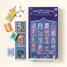 the christmas through the window book next to its matching wooden blocks and magnetic magnets