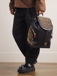 A backpack to get you noticed, Christian Louboutin's 'Explorafunk' is heavily embellished with gold-tone studs and accented with red in a nod to the iconic soles. It's been crafted in Italy from full-grain leather and has a drawstring-fastening interior alongside external zipped pockets for keeping essentials close to hand. Christian Louboutin Backpack, Luxury Red Backpack With Zipper Closure, Luxury Backpack With Zipper Closure For On-the-go, Luxury Black Leather Backpack For On-the-go, Luxury Black Leather Backpack With Gold-tone Hardware, Leather Wash Bag, Studded Backpack, Leather Backpack For Men, Latest Bags