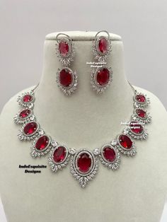 American Diamond Necklace Set / CZ Necklace/Indian Jewelry/ Reception Jewelry/ Bollywood Jewelry/ Silver Red  All items are shipped from Brampton, Ontario, Canada. If you need your item by a certain day, please reach out to us for express delivery option before placing the order so that we can update the shipping for you. Standard shipping/delivery timeline Below are the delivery timeline estimates. We dispatch all orders by the next business day. ---> USA delivery timeline * 3-6 business days to major urban centers in USA. It may take days extra to remote locations ---> Canada delivery timeline  * 2-3 business days - GTA  & Montreal  * 2-4  business days - Rest of Ontario/Quebec * 3-6 business days-  Rest of Canada    ---> Europe/Middle East timeline * 5-10 business days We kindly request Dazzling Ruby Necklace For Party, Ruby Round-shaped Jewelry Sets For Anniversary, Classic Silver Ruby Jewelry, Silver Ruby Jewelry With Stones, Round Ruby Necklace For Party, Classic Red Cubic Zirconia Jewelry, Red Ruby Round Necklaces, Classic Red Ruby Jewelry, Red Oval Cubic Zirconia Necklace