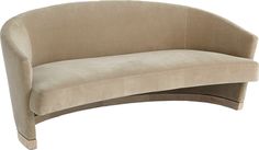 a curved beige couch sitting on top of a white floor