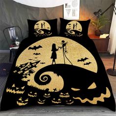 a bed with a black and gold cover that has a silhouette of a person on it