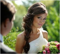 a beautiful young woman holding a bouquet of flowers