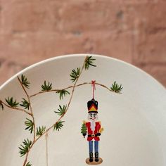 a white plate with a nutcracker painted on it's front and side