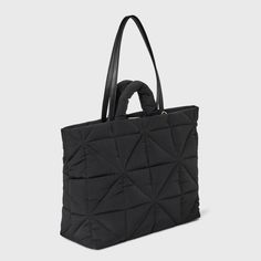 This Kate Tote Handbag from A New Day™ in a solid color showcases an unstructured silhouette with a geometric quilted finish for a chic, textured look and it goes well with any of your outfits. The interior accessories pocket, zip pocket and exterior side pockets help keep your belongings organized. Designed with a magnetic closure, this stylish tote handbag is easy to carry with double shoulder and grab handles. A New Day™: Style that goes wherever you do. Casual Black Quilted Bag, Textured Tote Shoulder Bag For Travel, Textured Travel Tote Shoulder Bag, Chic Everyday Bag With Geometric Shape, Trendy Black Geometric Bag, Black Quilted Square Bag, Black Square Quilted Bag, Chic Quilted Tote Bags, Chic Quilted Shopping Bag