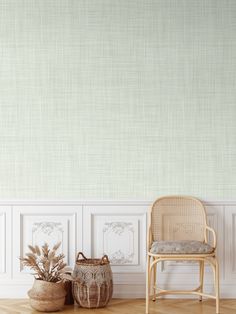 a chair and basket in front of a wall with white paneling on the walls