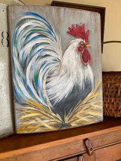 a painting of a rooster sitting on top of a dresser