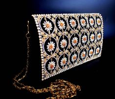 "Vintage inspired new hand embroidered black velvet evening bag, using metallic threads and embellished with genuine semi precious stones, giving a 3D effect. Surrounded by a picture frame of faux pearls. Versatile - wear it on the shoulder for hands free convenience, or wear it in the hand with a double loop, or tuck the strap inside. Hand embroidered in intricate detail by master zardozi artisans. The word Zardozi means \"gold thread\". It is an elaborate and intricate embroidery using metalli Elegant Black Hand-embellished Bag, Elegant Hand Embellished Black Bag, Elegant Black Hand-embellished Clutch, Elegant Black Hand Embellished Clutch, Black Hand Embellished Evening Bag, Hand Embellished Black Evening Bag, Luxury Black Hand Embellished Evening Bag, Luxury Hand Embellished Black Evening Bag, Luxury Hand-embellished Black Evening Bag