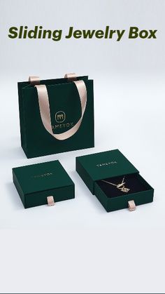 a green jewelry box with two matching necklaces