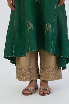 Dark green A-line kurta with aari embroidered parrot motifs and side asymmetric panels. Comes with sequin, zardozi floral embroidered hem beige pant. - Aza Fashions Embroidered Parrot, Green Parrot, Embroidered Hem, Women Kurta, A Line Kurta, Beige Pants, Straight Kurta, Set Women, Green Silk