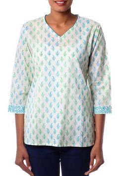 Paisleys flourish with hypnotic elegance in the design of this cotton tunic from Isha Jain. Featuring a v-neck and ?? length sleeves the white tunic's patterns are expertly printed by hand in shades of blue and green with wood blocks. The tunic is trimmed with turquoise blue piping. Long Sleeve Vintage Dresses, Indian Paisley, Tunic Sewing Patterns, Trendy Outfits Indian, Women Tunic, Womens Tops Dressy, Cotton Tunic, Embellished Blouse, Shirts Women Fashion