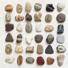 many different types of rocks on a white surface