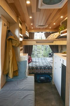 the interior of a camper with bunk beds, cabinets and cupboards in it