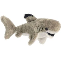 a stuffed toy shark with teeth hanging from it's mouth