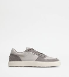 A sporty and sophisticated taste characterizes these sneakers with basketball-inspired upper, and side Tod's logo. Crafted in calfskin suede with smooth leather inserts, they come with a rubber outsole with embossed rubber pebbles. Grey Sneakers, Back To Black, Smooth Leather, Calf Skin, Baskets, Dust Bag, Online Shop, Basketball, ? Logo