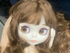 a close up of a doll with long hair