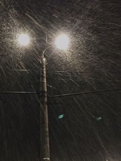 a street light in the snow at night