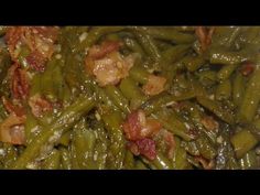 green beans and bacon are mixed together in a bowl with some seasoning on top