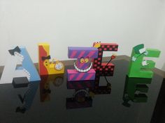 the letters are made out of paper and have faces on them, as well as numbers