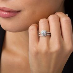 a close up of a person wearing a ring with a diamond on the middle finger