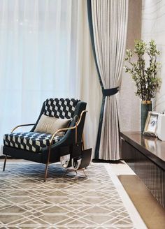 a black and white chair sitting in front of a window