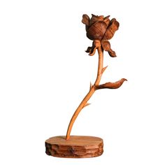 a wooden sculpture of a flower on a white background