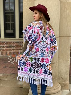 This Beautiful Hand Embroidered Poncho is perfect for keeping you warm and stylish at the same time. It has gorgeous hand embroidered details in both the front and back of the poncho. This poncho is handmade by Mexican Artisans and is completely one of a kind. Note: This poncho has open sides and comes in one size which is ideal for sizes, Small, Medium, Large, Extra Large, 2x, 3x. Multicolor Embroidered Bohemian Poncho, Handmade Folk Shawl For Festival, Multicolor Long Folk Kimono, Multicolor Long Folk Style Kimono, Traditional Handmade Multicolor Kaftan, Folk Style Festival Kimono With Multicolor Embroidery, White Bohemian Shawl For Festivals, Bohemian Summer Patterns In White, Folk Style Multicolor Embroidered Kimono For Festivals