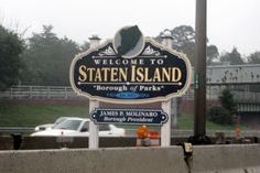 a welcome sign to staten island in the rain