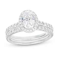 Make a standout statement of affection with this dazzling oval lab-created diamond frame bridal set. Fashioned in 14K white gold The engagement ring showcases a 1 ct. certified oval-shaped lab-created diamond boasting a color rank of I and clarity of Si2. Lab-created diamonds line the halo frame and the shank. Seal your vows with the coordinating lab-created diamond-lined wedding band. Includes certification card This bridal set captivates with 1-3/4 cts. t.w. of lab-created diamonds. Oval Diamond Bridal Sets For Anniversary, Oval Brilliant Cut Bridal Sets For Anniversary, Oval Bridal Sets With Center Stone For Anniversaries, Oval Diamond Bridal Sets With Center Stone, Oval Bridal Sets With Prong Setting, Formal Oval Bridal Sets With Prong Setting, Oval Bridal Sets With Center Stone, Oval Diamond Bridal Sets For Formal Occasions, Anniversary Bridal Sets With Oval Cubic Zirconia