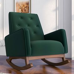 a green rocking chair sitting on top of a hard wood floor