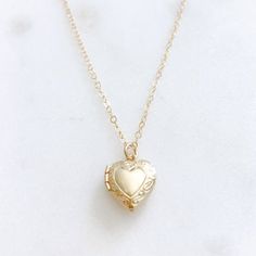 DESCRIPTION: The CHARLOTTE Necklace - Gold Heart Locket on a dainty gold filled chain. We love this sweet little necklace and think you will too! Insert a treasured photo and keep it close to your heart! The cutest way to show your love for someone special!MATERIALS:Chain, Clasp, Jump Rings - Gold Filled  Locket - Gold PlatedPENDANT SIZE:Approximately 1/2” in lengthPACKAGING:Your necklace will arrive on a Dainty Doe signature jewelry card placed in a white jewelry box, with a bow and tag, perfec Dainty Open Heart Locket Necklace, Dainty Heart Pendant Locket Necklace With Delicate Chain, Dainty Open Heart Locket Necklace With Heart Charm, Dainty Heart Pendant Locket Necklace With Charm, Heart Shaped Dainty Locket Necklace With Delicate Chain, Dainty Heart Locket Necklace With Charm, Dainty Heart Locket Necklace With Delicate Chain, Dainty Heart Locket Charm Necklace, Dainty Open Heart Locket Necklace For Keepsake