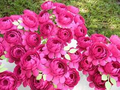 pink flowers are in a vase on the ground