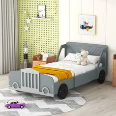 a child's bedroom with a toy car on the floor