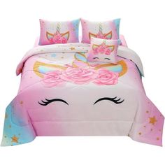 a pink bed with an unicorn face and stars on it